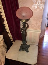 matching brass lamp on top of matching marble top side table