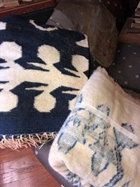 Old woven blankets one with thunderbirds and other with animal figures. 
