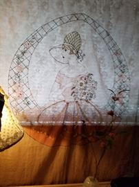 Vintage needlework bed cover hung as a window covering. So pretty and delicate.