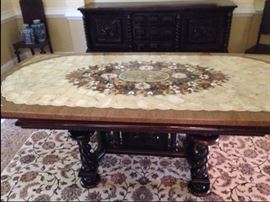 Early 1900's Brazilian colonial dining room set. Table measures 43 x 86 and has custom inlaid marble top with a floral mosaic center of multiple colored Brazilian stones. The table is bordered in marble and has corner accents of onyx and marble stones. 