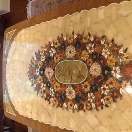 Early 1900's Brazilian colonial dining room set. Table measures 43 x 86 and has custom inlaid marble top with a floral mosaic center of multiple colored Brazilian stones. The table is bordered in marble and has corner accents of onyx and marble stones. 