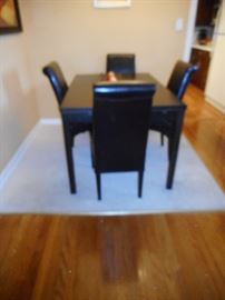 Mobler Furniture. Sleek Modern Deep Gray with 4 Black Leather Side Chairs. Table on each end extends. Made in Denmark. Purchased 2004