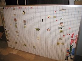 Large, divided long term planning board. Magnetic numbers/dates and magnetic tiles used for planning.  8 ft. in length. 