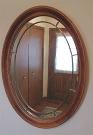 Walnut fancy oval mirror.