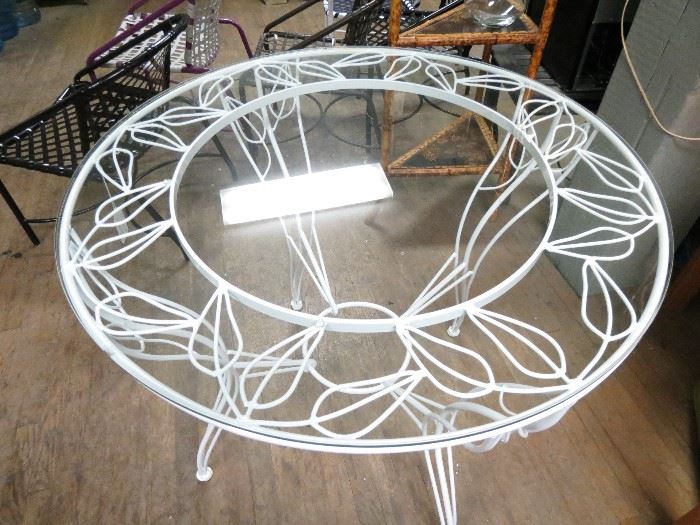 Vintage wrought iron table all done by hand with glass top.  Restored in powder coated snow white finish.