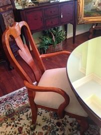 One of four chairs around the antique oak table