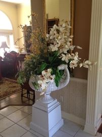 Striking arrangement in white urn on pedestal