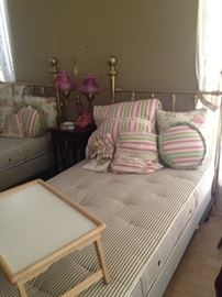 One of two twin brass beds