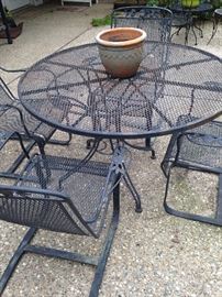 Round black patio table with 4 spring chairs