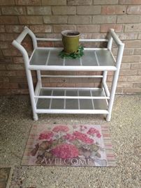 2 shelf white cart; "welcome" mat