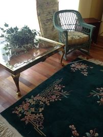 Solid brass square coffee table; pale green wicker rocker; good-looking rug