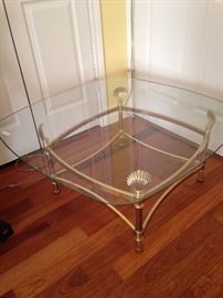 One of two glass top coffee tables