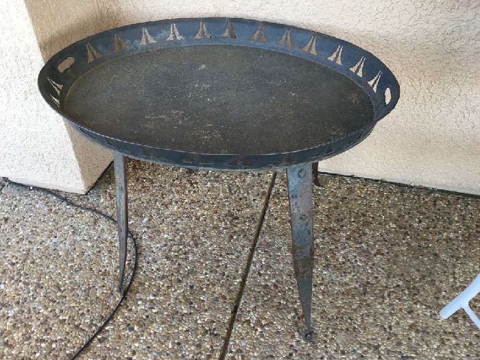 HAND FORGED COCTAIL TABLE, WITH IRON HINGES FOR LEGS. FOLK ART METAL TRAY TOP LIFTS OFF FOR SERVING.
