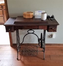 Antique sewing machine with cabinet treadle 