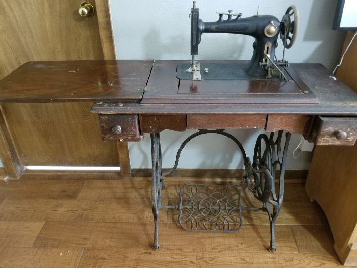 Antique sewing machine with cabinet and treadle