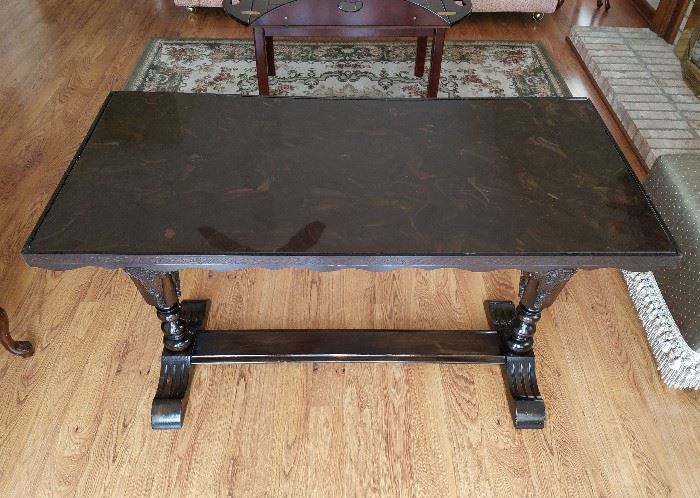 Vintage, solid wood, library table with carved trestle base and marble top.  49" wide, 24" deep, 30" tall.