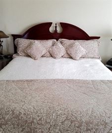 King size bed:  Dark Cherry headboard, curved top with pediment and beaded detail.  Includes frame, mattress and box spring.