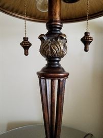 Table lamp with "bronze look" glass shade, dual pull-chain light, metal & composite base and fleur de lis finial.