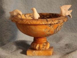 Marble bird bath with birds alighting