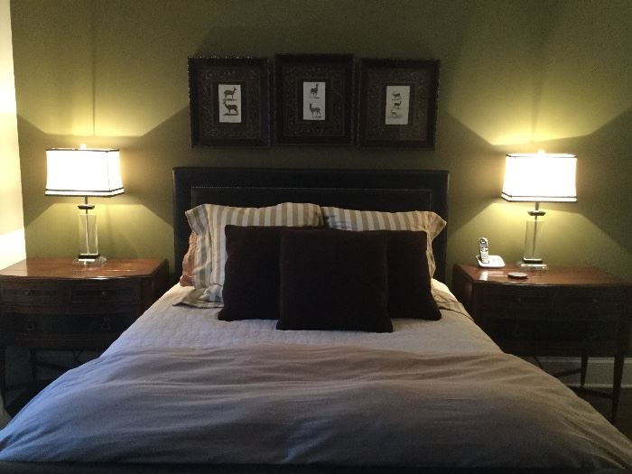 Master bedroom leather headboard, matching side tables and lamps, artwork on wall