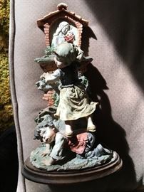 Lots of collectible sculptures and figures, this one G. Armani