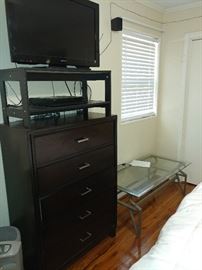 chest of drawers, flat screen tv, glass top coffee table