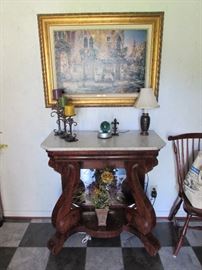 Empire style antique entry table with lovely marble top.  Cayo painting in gilded frame.  Candle decor, floral, lamp.