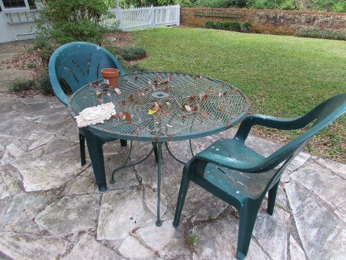 Wrought iron table, two plastic chairs