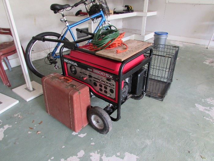 Honda generator, dog cage, suitcase contains a vintage accordian.  Bike not included in sale