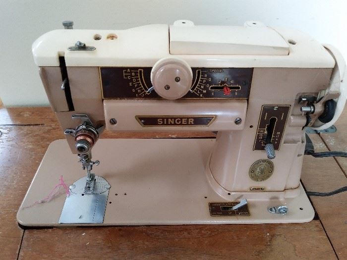 Singer sewing machine in cabinet    Buy it now online 75.00