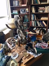 Black Memorabilia on desk in the study. Awards, books, African art, statues, certifications, sculptures, Mid Century Modern sculpture, Mud cloth.