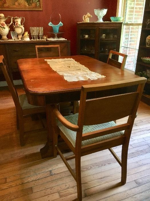 Vintage 1940s walnut dining room group includes table and 5 chairs, buffet and china cabinet. (Veneer is loose on buffet.)