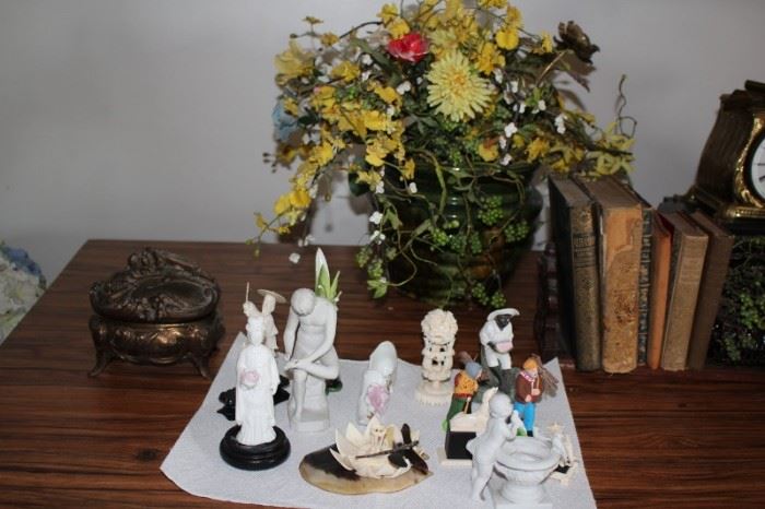 Figurines and Vintage Books with Decorative Boxes and Flower Arrangement