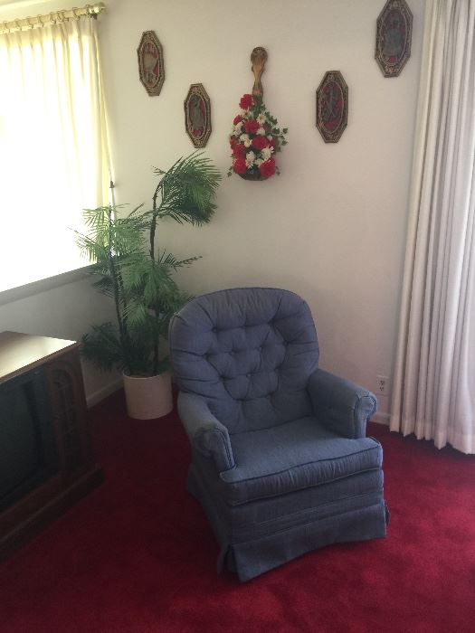 Swivel chair and wall art and plastic plant