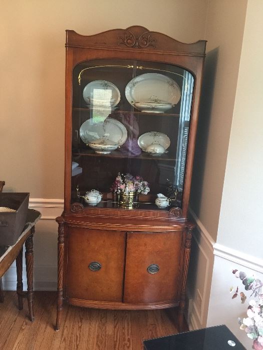China cabinet with gold accents on glass doors