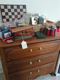 small dresser, poker chips, dominoes, laying cards, marble chess set, backgammon travel