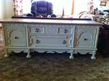 Footed two drawer credenza with side cupboards. Carved fronts, solid oak.