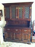 c 1960's dark pine china hutch with retro glass fronts. Four doors on top, Three drawers, and three cabinets on bottom. Top separates from bottom.