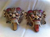 Wooden hand painted wood dance masks, each of a fanged dragon with bulging eyes