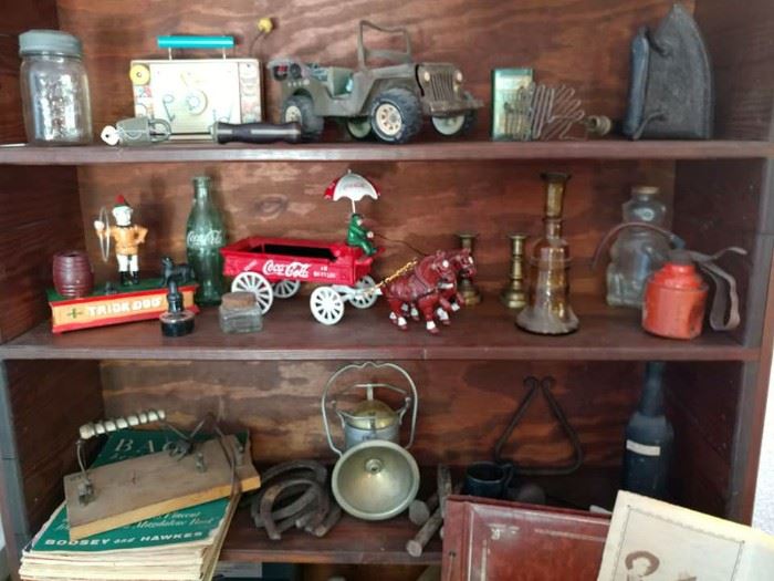 vintage, antique hutch, cast iron toys, cast iron bank, antique railroad lantern, horse shoes, antique wine bottle, vintage toy, cast iron iron