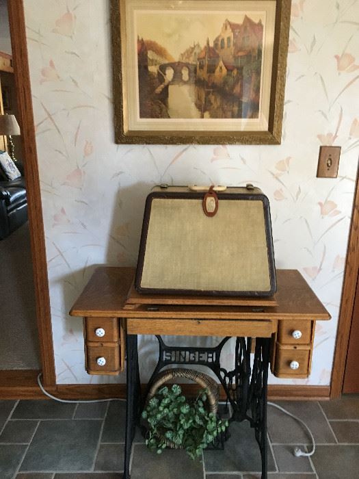 Vintage Treadle Singer Sewing Machine cabinet. The Cased sewing machine is a Singer Featherweight 301W