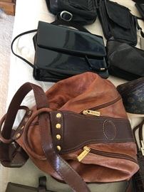 Loads of Womens Purses and Back packs with names such as Borgo Giovanni, Sharper Image, Dooney and Bourke, and of course Coach