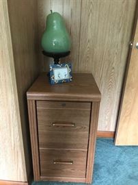 Wood filing cabinet and ceramic pear decor