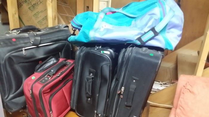 Suitcases, large good duffel bag, hardly used red computer bag with handle and rollers.