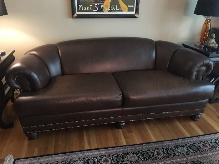 Excellent quality chocolate brown leather sofa with nailhead details, great condition except for some slight discoloration on the left cushion near the side of the armrest
