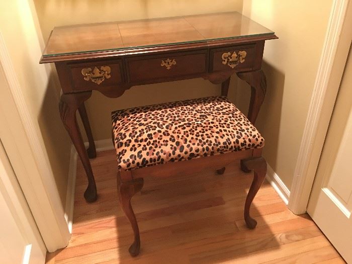 Early-American style vanity with custom-cut glass top and matching stool with leopard print UltraSuede fabric