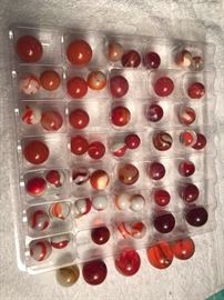 55 assorted red collectible marbles