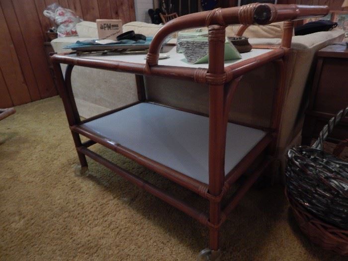 Rattan bar cart on wheels. One of many rattan pieces in the home. Furniture was made in Porto Rico