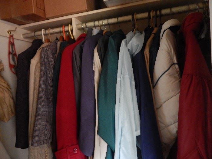 Hallway closet full of coats.