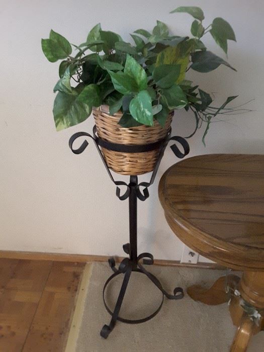 Wrought Iron Plant Stand with Woven Basket and Fake Ivy Plants.